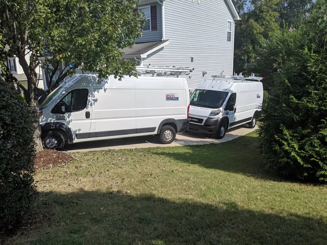 Roy Electric service vans at a job