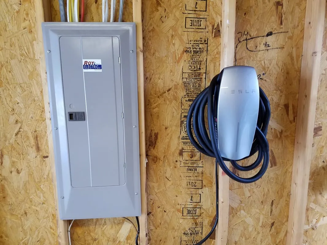 Tesla Wall Connector beside a new panel